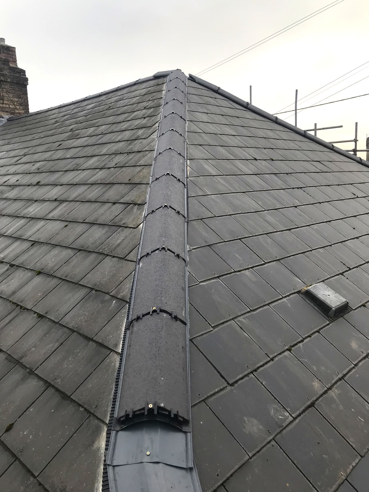 Grey ridge and hip system on a slate roof